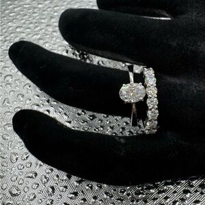 Elegant 1 carat moissanite and half eternity ring set in 14k white gold.